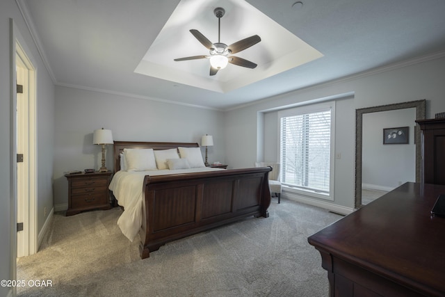 carpeted bedroom with crown molding, ceiling fan, and a raised ceiling