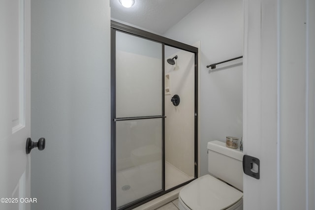 bathroom featuring toilet and an enclosed shower