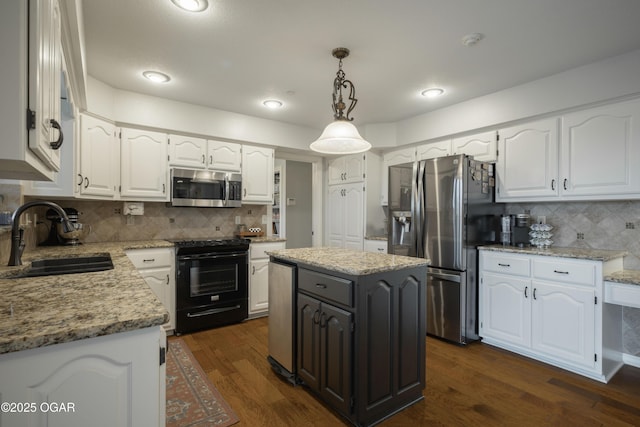 kitchen featuring white cabinetry, sink, appliances with stainless steel finishes, and a kitchen island