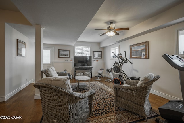 living room with dark hardwood / wood-style floors and ceiling fan