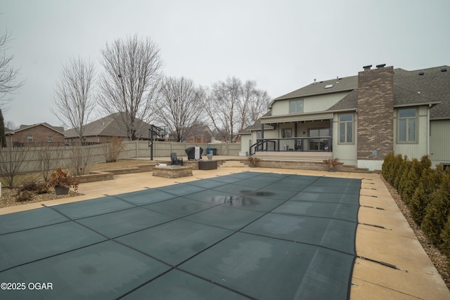 view of swimming pool featuring a fire pit and a patio area