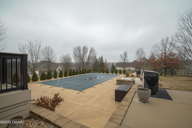 view of swimming pool with area for grilling and a patio area