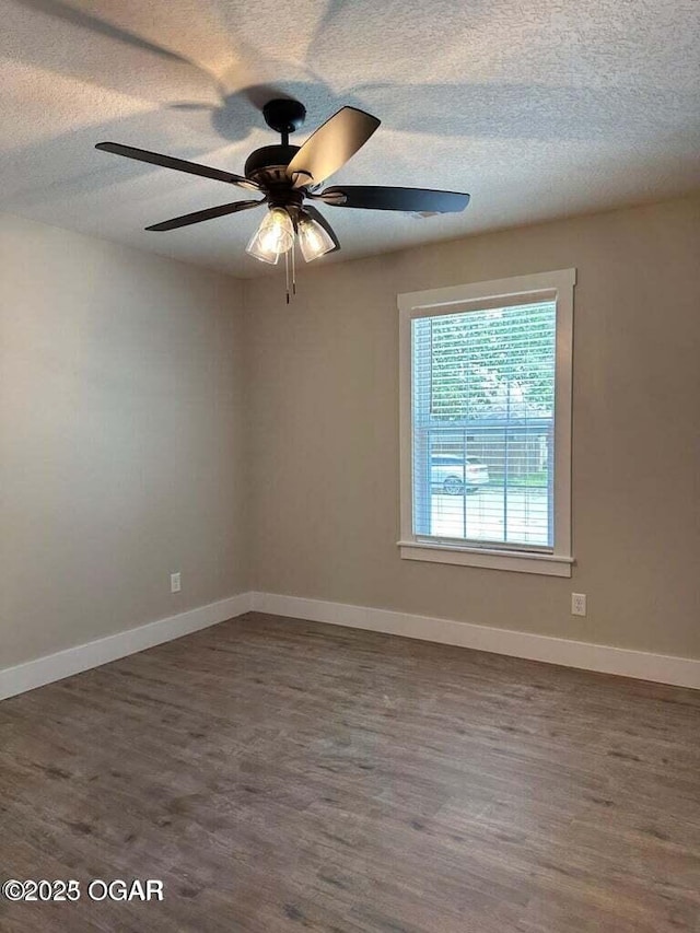 unfurnished room with ceiling fan, a textured ceiling, and dark hardwood / wood-style flooring