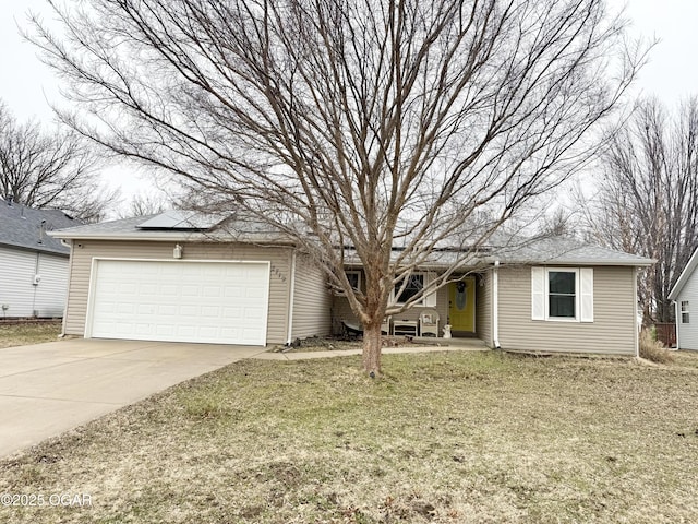 single story home featuring a garage, a front lawn, and solar panels