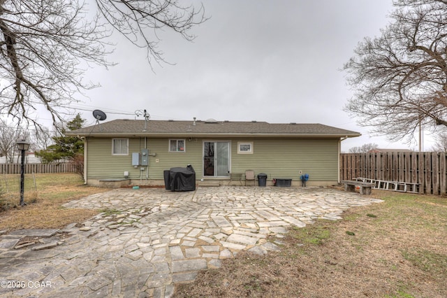 back of house featuring a yard and a patio area