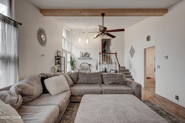 living room with beamed ceiling, hardwood / wood-style floors, and ceiling fan