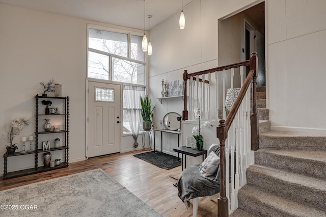 foyer entrance featuring a high ceiling and hardwood / wood-style floors