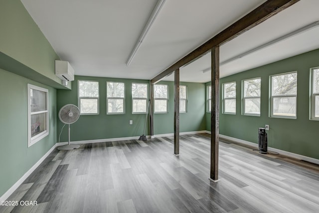 interior space with beam ceiling and a wall unit AC