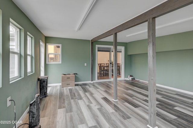 interior space featuring light hardwood / wood-style flooring and beamed ceiling