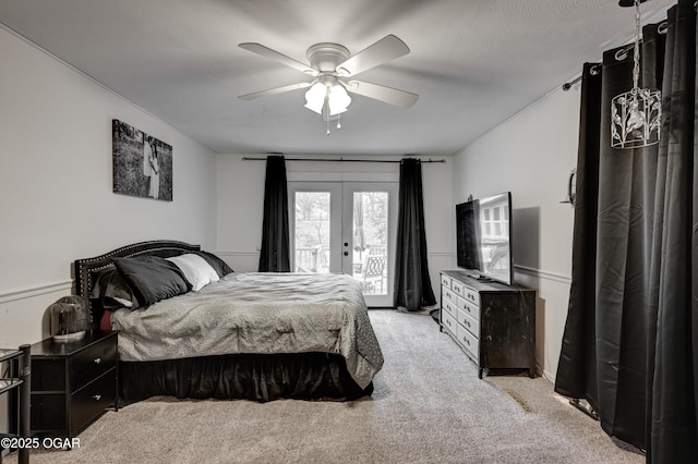 carpeted bedroom featuring access to outside, ceiling fan, and french doors