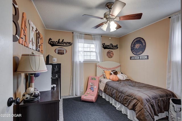 bedroom with ceiling fan, carpet flooring, and a textured ceiling