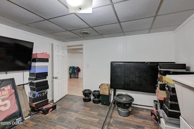 interior space featuring dark hardwood / wood-style flooring and a drop ceiling