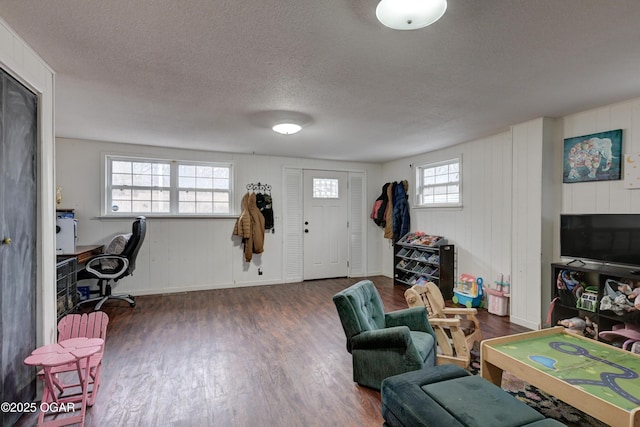 living room featuring dark hardwood / wood-style floors and a textured ceiling