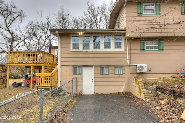 rear view of house with a deck and ac unit