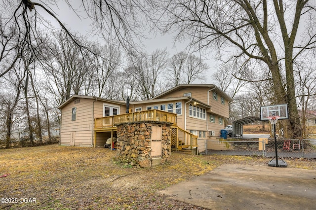 rear view of house featuring a wooden deck