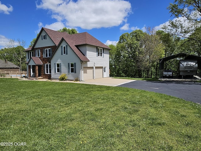 view of front of home with a shingled roof, aphalt driveway, a garage, a front yard, and a carport