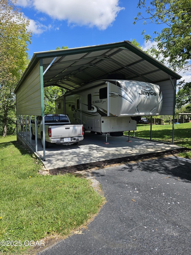 view of car parking with aphalt driveway and a carport