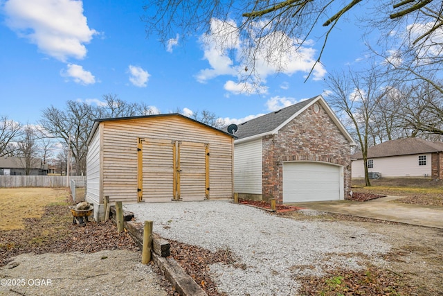 exterior space with a garage and an outbuilding