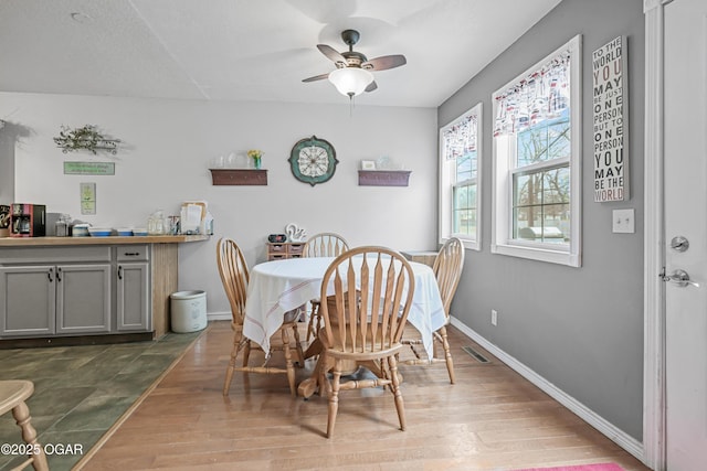 dining space featuring hardwood / wood-style flooring and ceiling fan