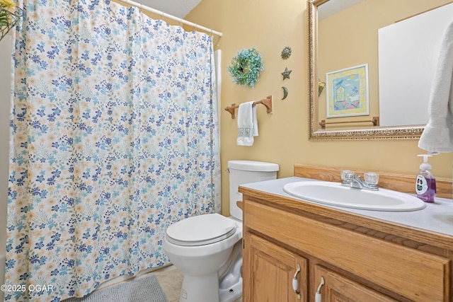 bathroom featuring vanity, tile patterned floors, and toilet