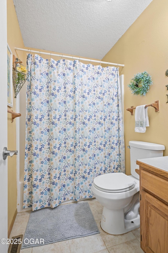 bathroom with vanity, toilet, tile patterned floors, a textured ceiling, and a shower with curtain