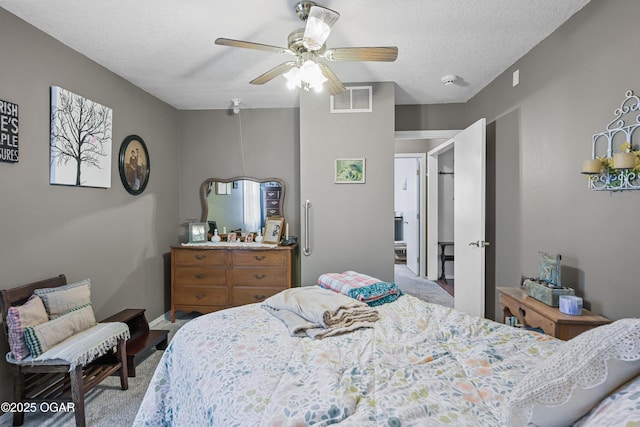 bedroom featuring ceiling fan and a textured ceiling