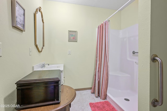 bathroom with vanity, curtained shower, and tile patterned floors