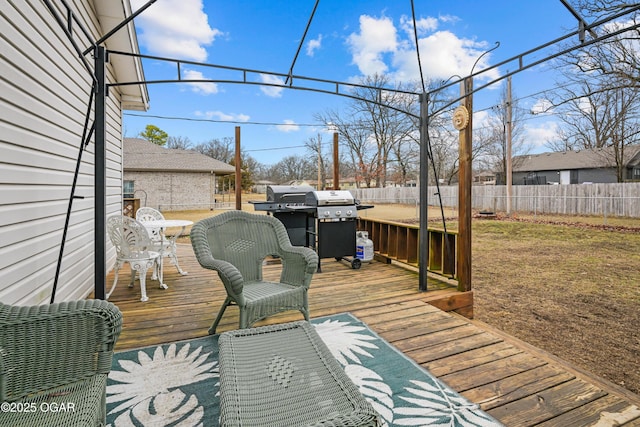 wooden terrace featuring a lawn