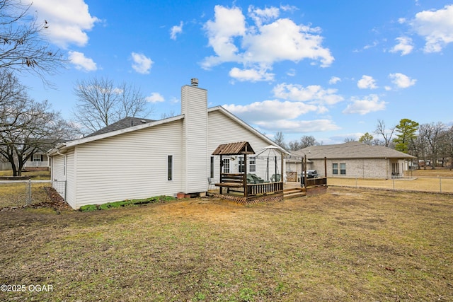 rear view of property featuring a yard, a gazebo, and a deck