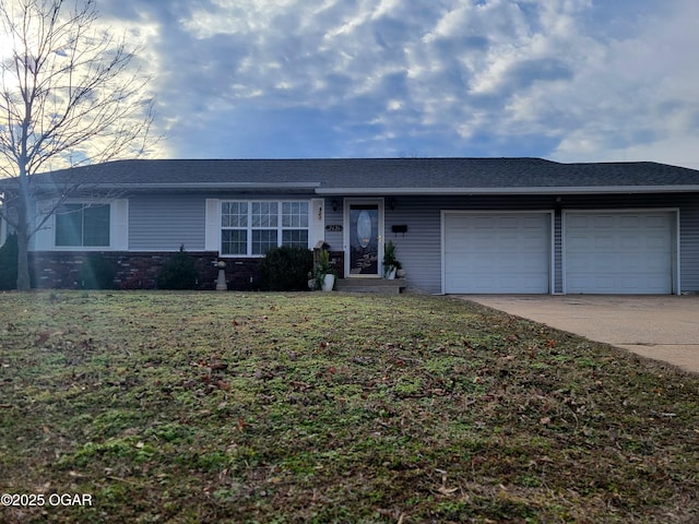 ranch-style home with a garage and a front yard