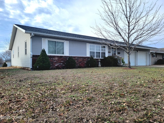 ranch-style house with a garage and a front lawn