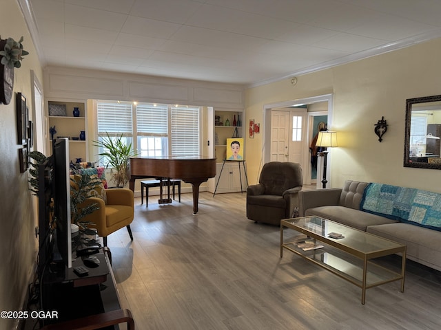 living room with ornamental molding and light hardwood / wood-style floors