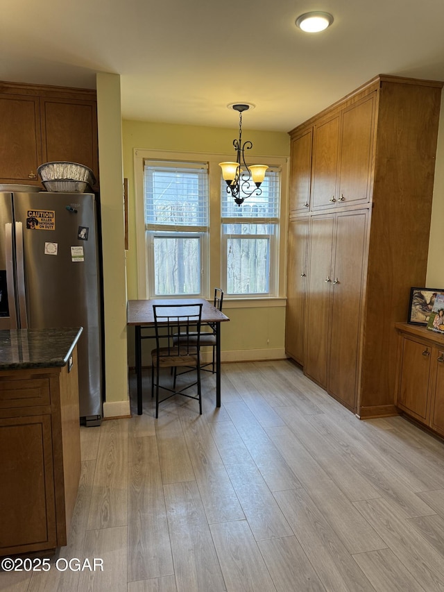 dining room with a chandelier and light hardwood / wood-style floors