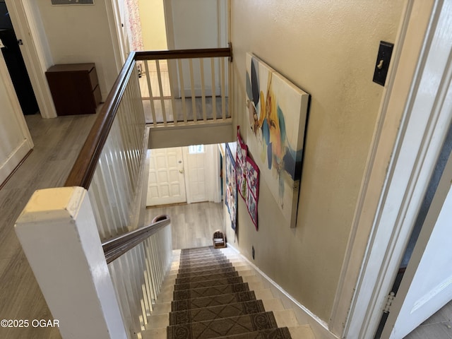 stairway featuring a towering ceiling