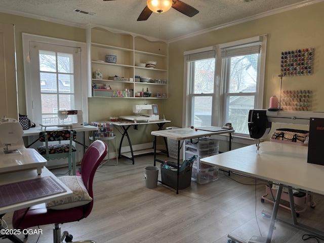 office area with ceiling fan, ornamental molding, light hardwood / wood-style floors, and a textured ceiling