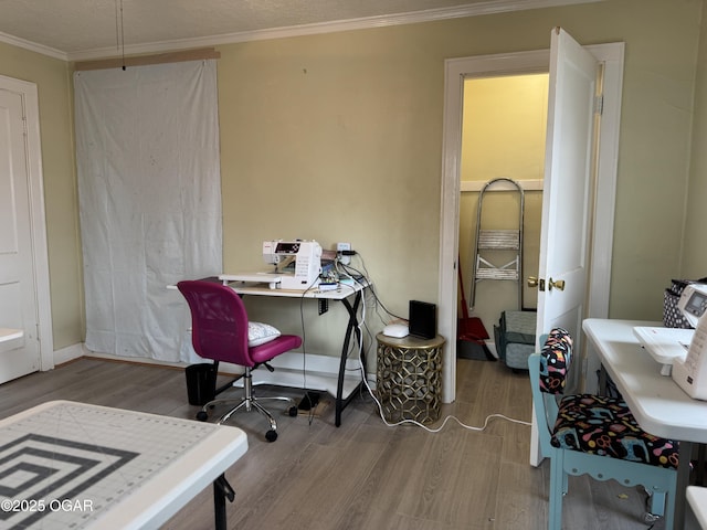 home office with hardwood / wood-style flooring and crown molding