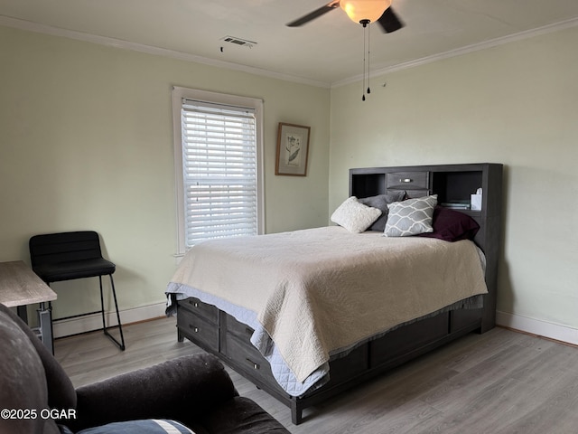 bedroom with ceiling fan, ornamental molding, and light hardwood / wood-style flooring