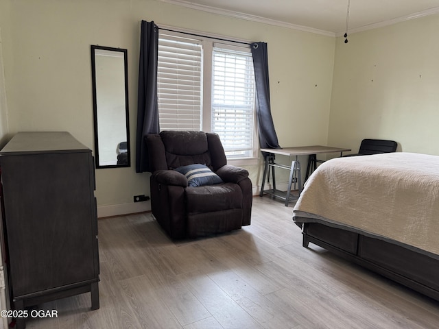 bedroom with crown molding and light hardwood / wood-style floors