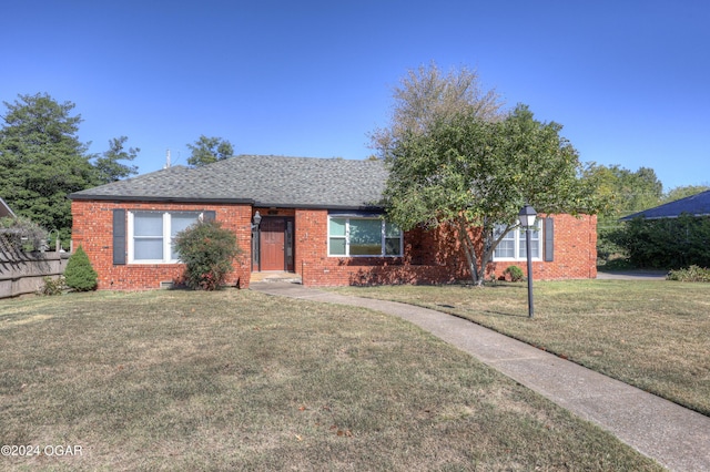 ranch-style home featuring a front yard