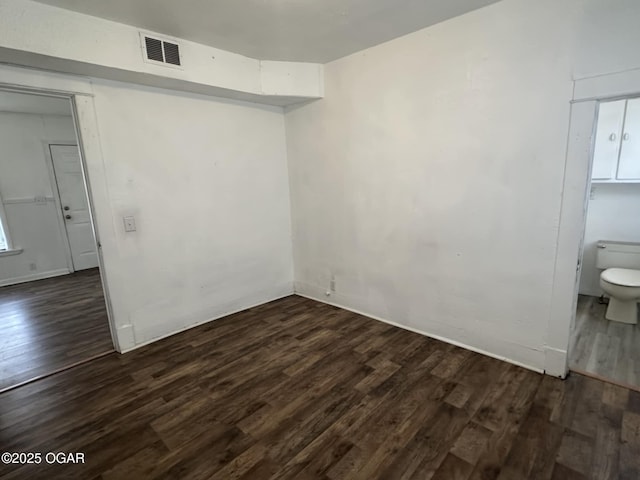 spare room featuring dark hardwood / wood-style floors