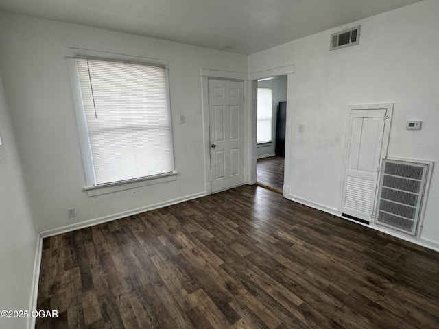 empty room featuring dark wood-type flooring