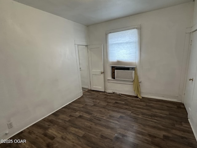 spare room with cooling unit and dark hardwood / wood-style floors