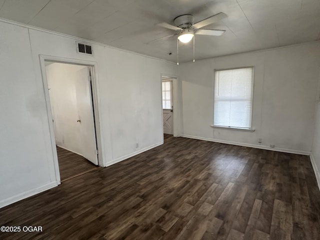 spare room with dark wood-type flooring and ceiling fan