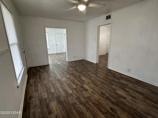 empty room featuring dark wood-type flooring and ceiling fan