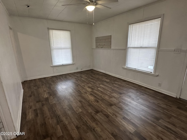 spare room featuring dark hardwood / wood-style flooring and ceiling fan