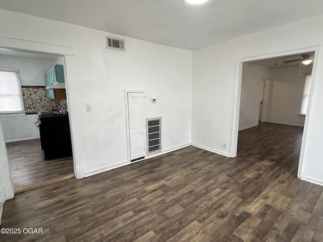 empty room with ceiling fan and dark hardwood / wood-style floors