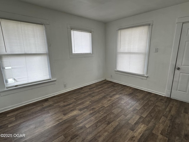 spare room with dark hardwood / wood-style floors