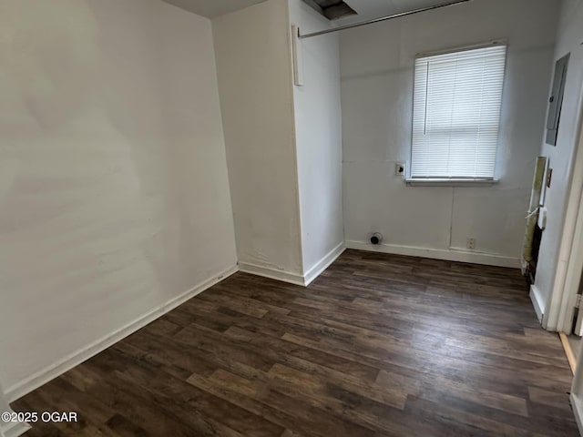 unfurnished room with dark hardwood / wood-style flooring