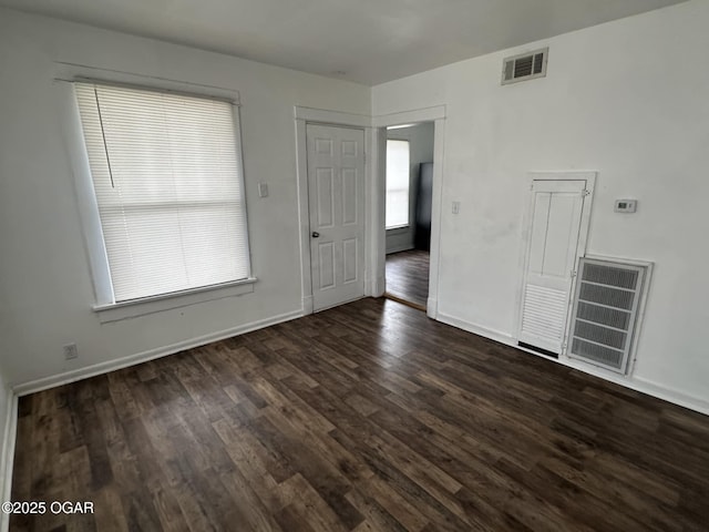 empty room with dark wood-type flooring