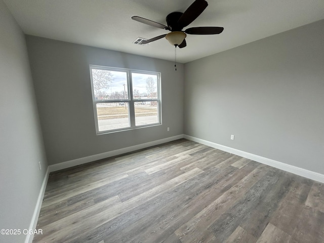 empty room with ceiling fan and light hardwood / wood-style floors